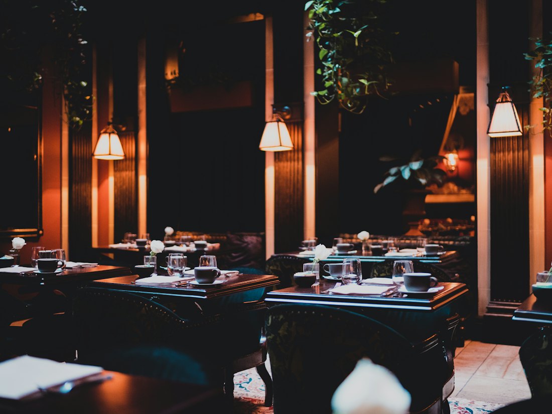 Warm restaurant dining room with set tables
